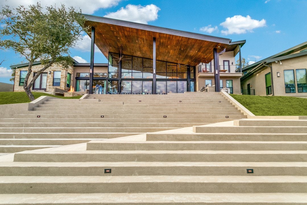 El Regalo custom lake home positioned on its lakeside terrain in Chico, Texas