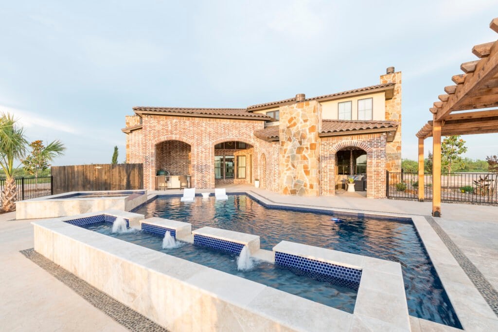 Brick and stone home with a swimming pool, spa and timber pergola